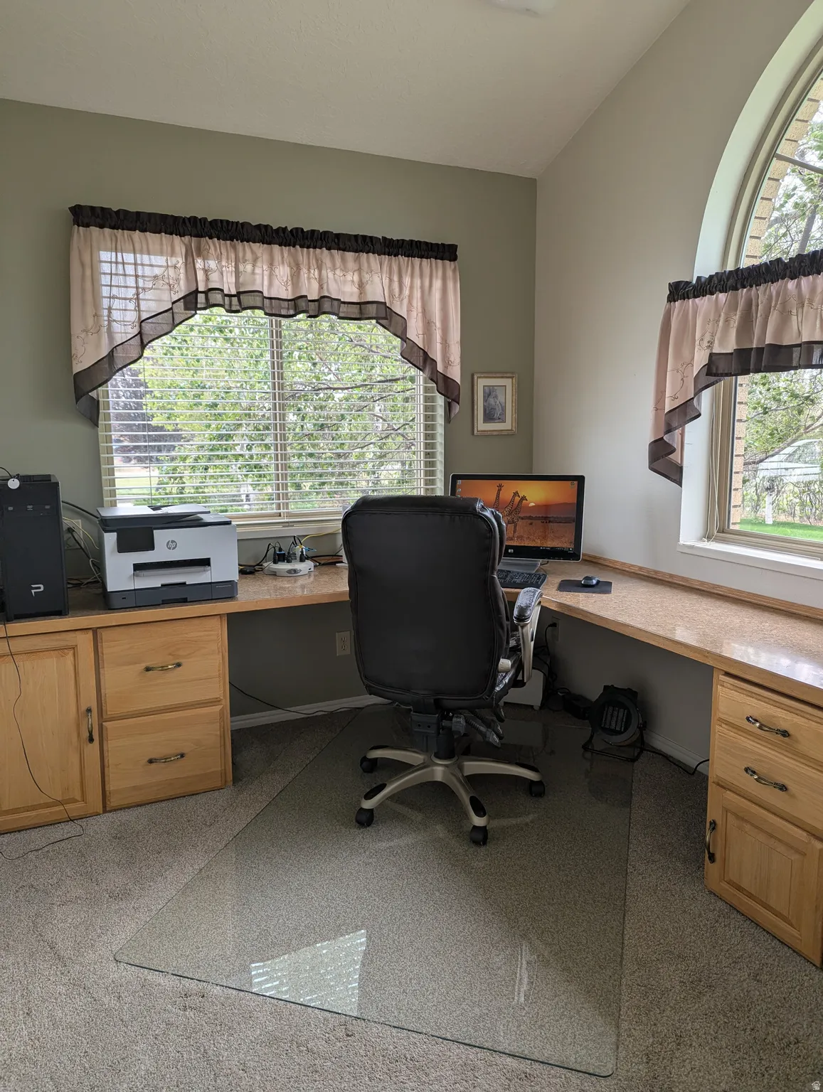 Built-in L-shaped desk with wood-finish cabinetry