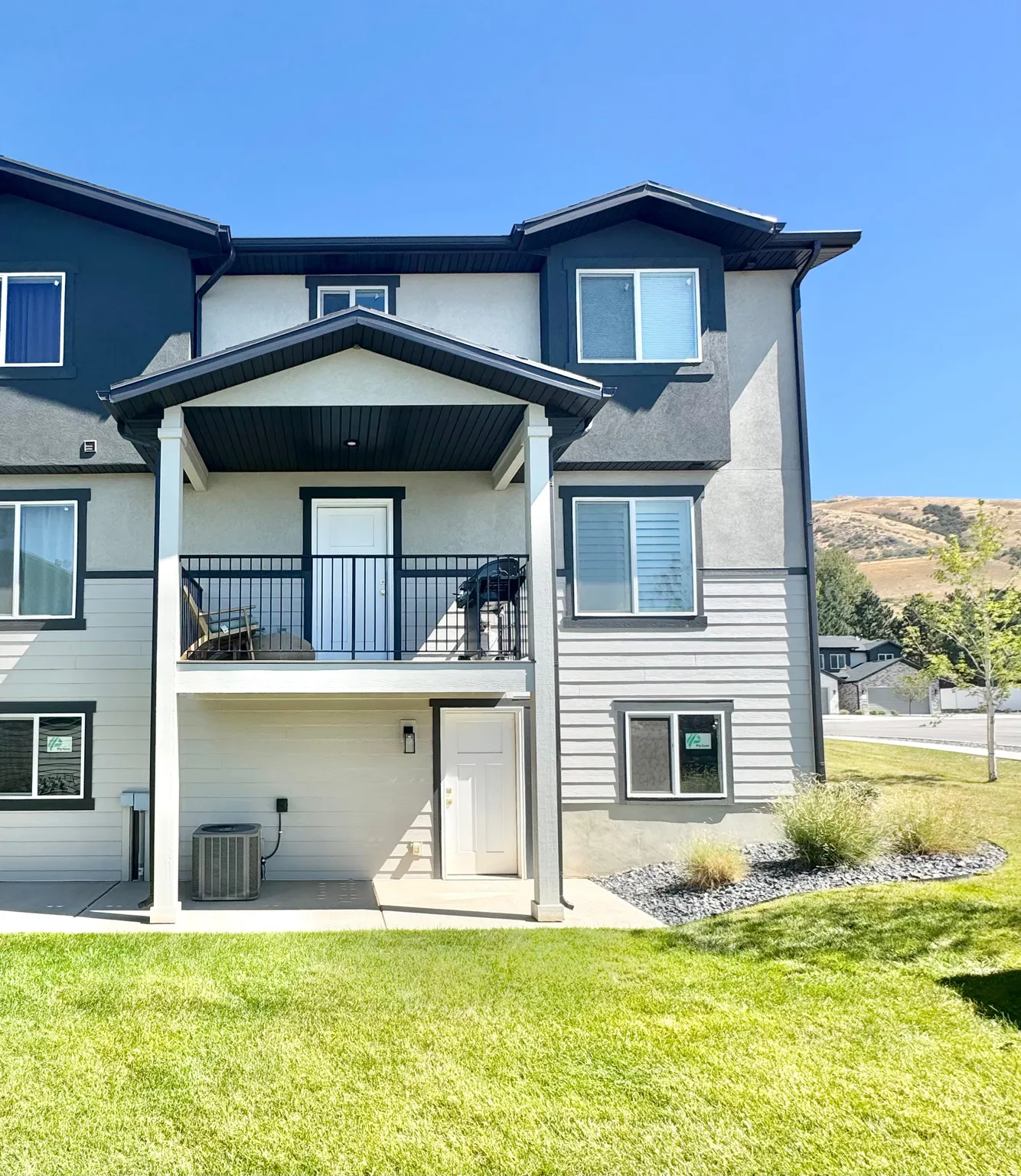 Modern two-story residence featuring a clean architectural design with mixed siding materials, including board-and-batten and horizontal lap siding