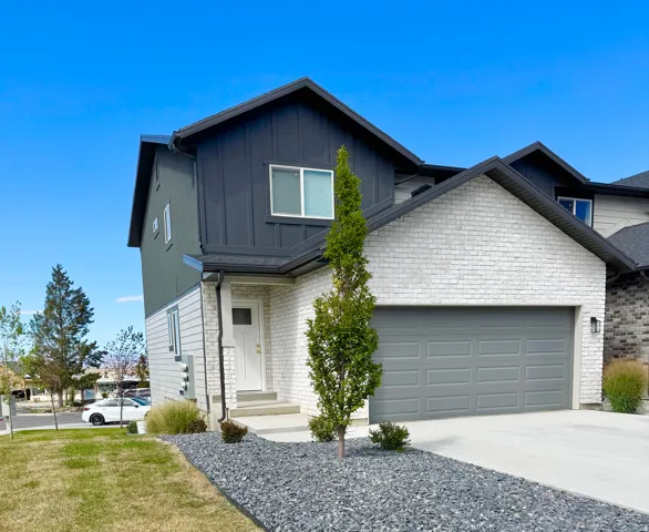 Contemporary exterior featuring white brick and dark gray siding