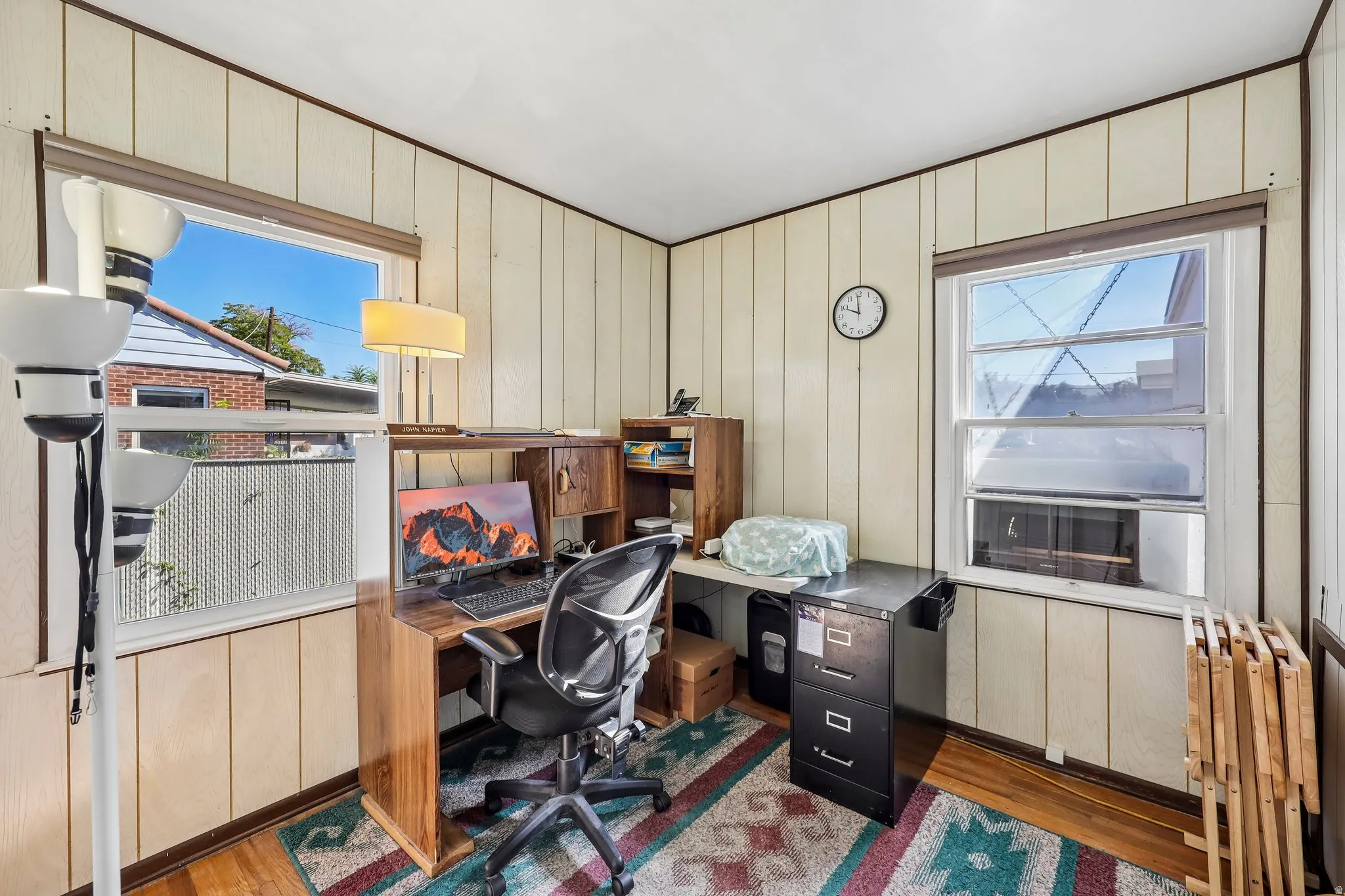 Wood-finish flooring with vertical paneling walls and trim
