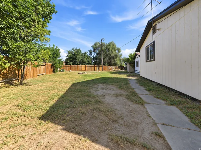 Expansive yard space with a wooden privacy fence