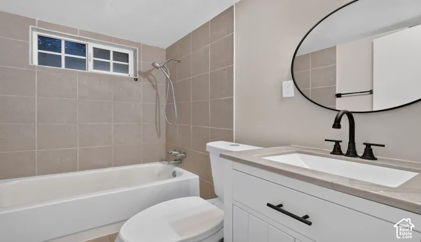 White vanity with dark hardware, rectangular sink, and stone-finish countertop