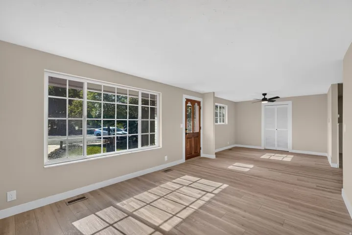 Spacious interior with neutral wall tones and wood-finish flooring