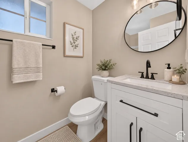 White vanity with black hardware, integrated sink, and light-toned countertop