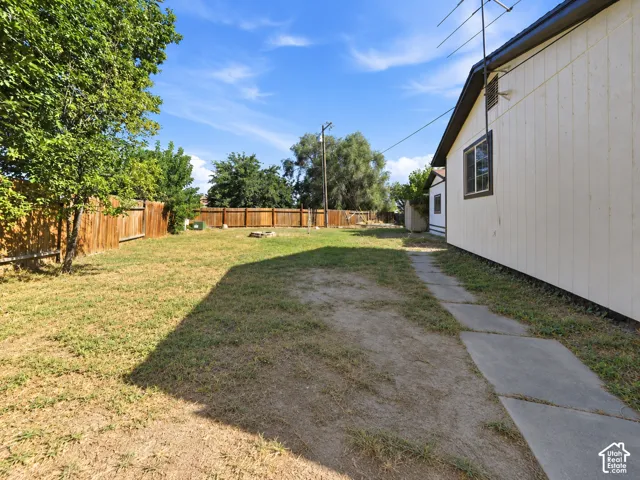 Expansive yard space with a wooden privacy fence