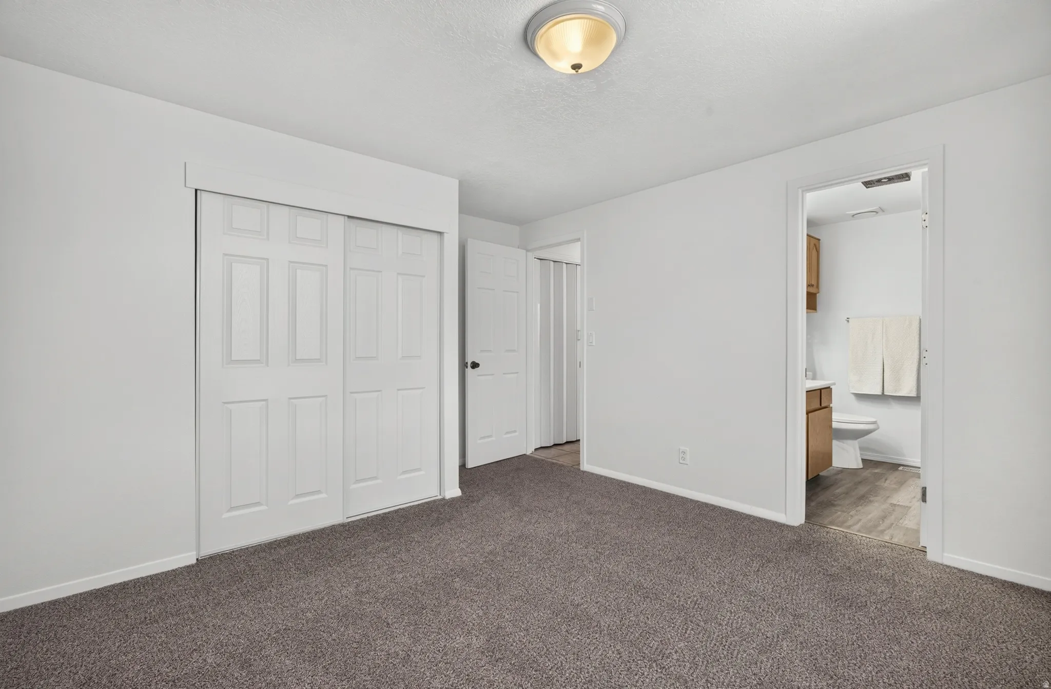 Wall-to-wall carpeting and white walls