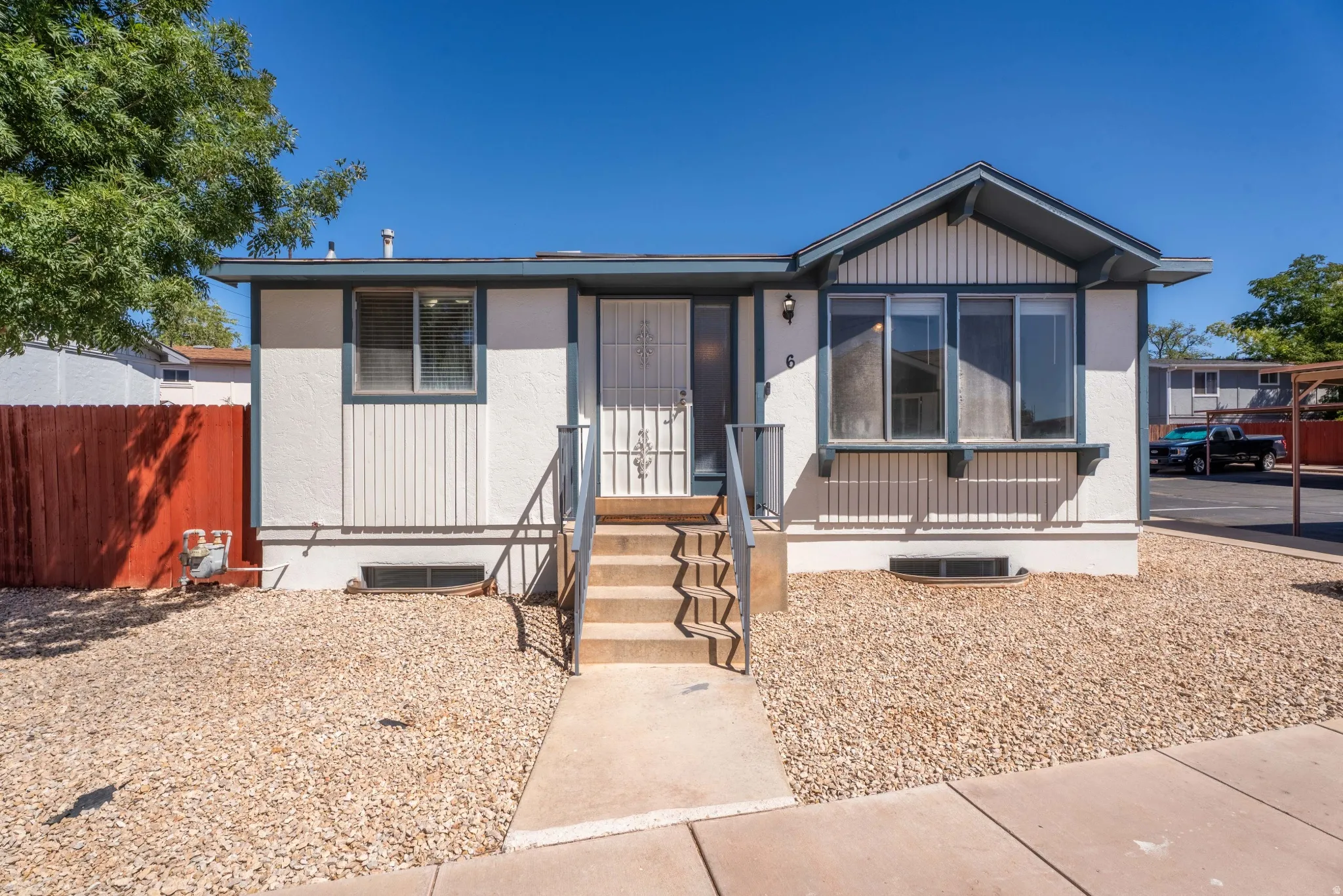 White exterior with gray trim and board and batten detailing
