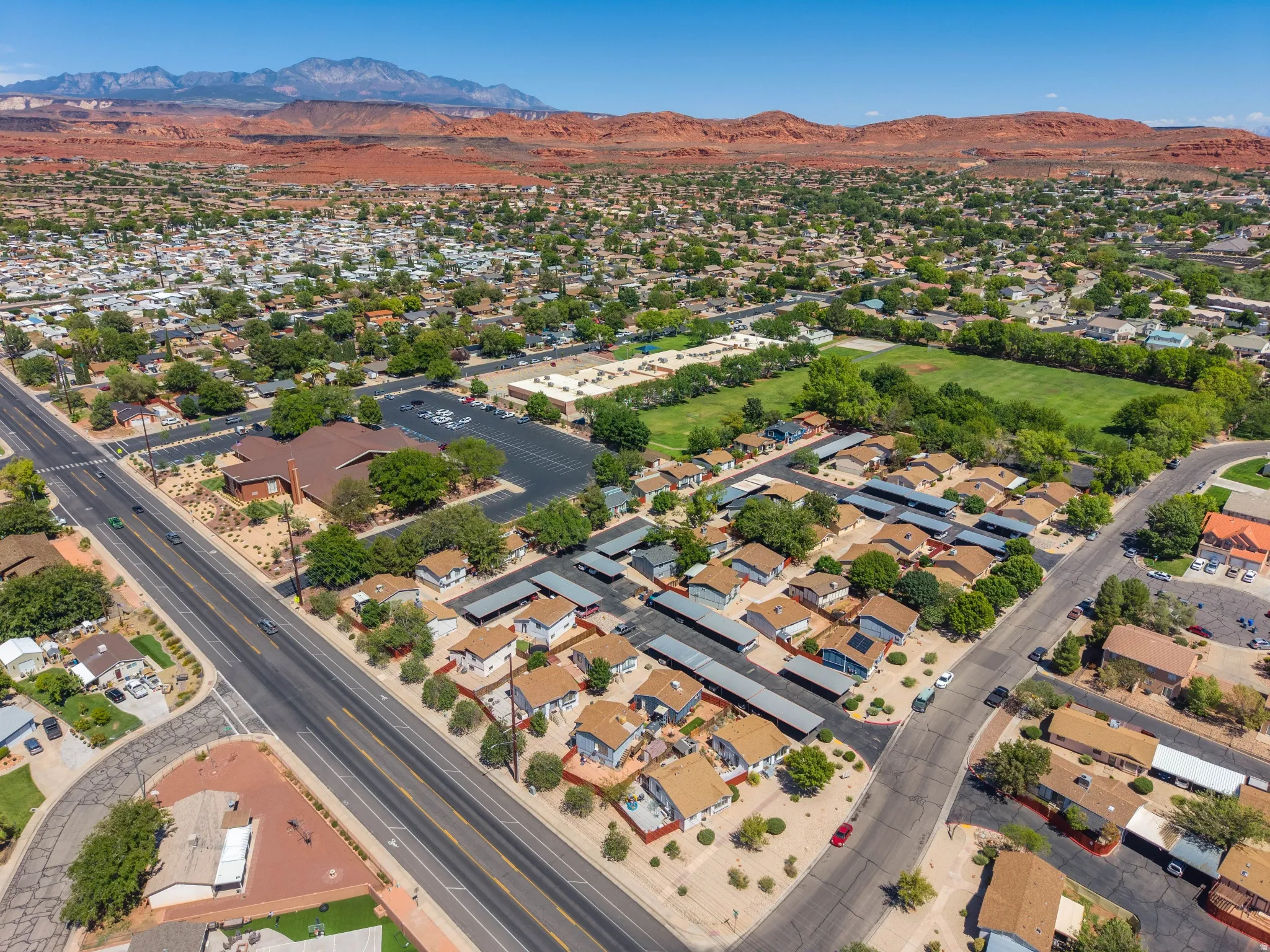 Aerial perspective showcasing a residential community with mature trees and paved roadways