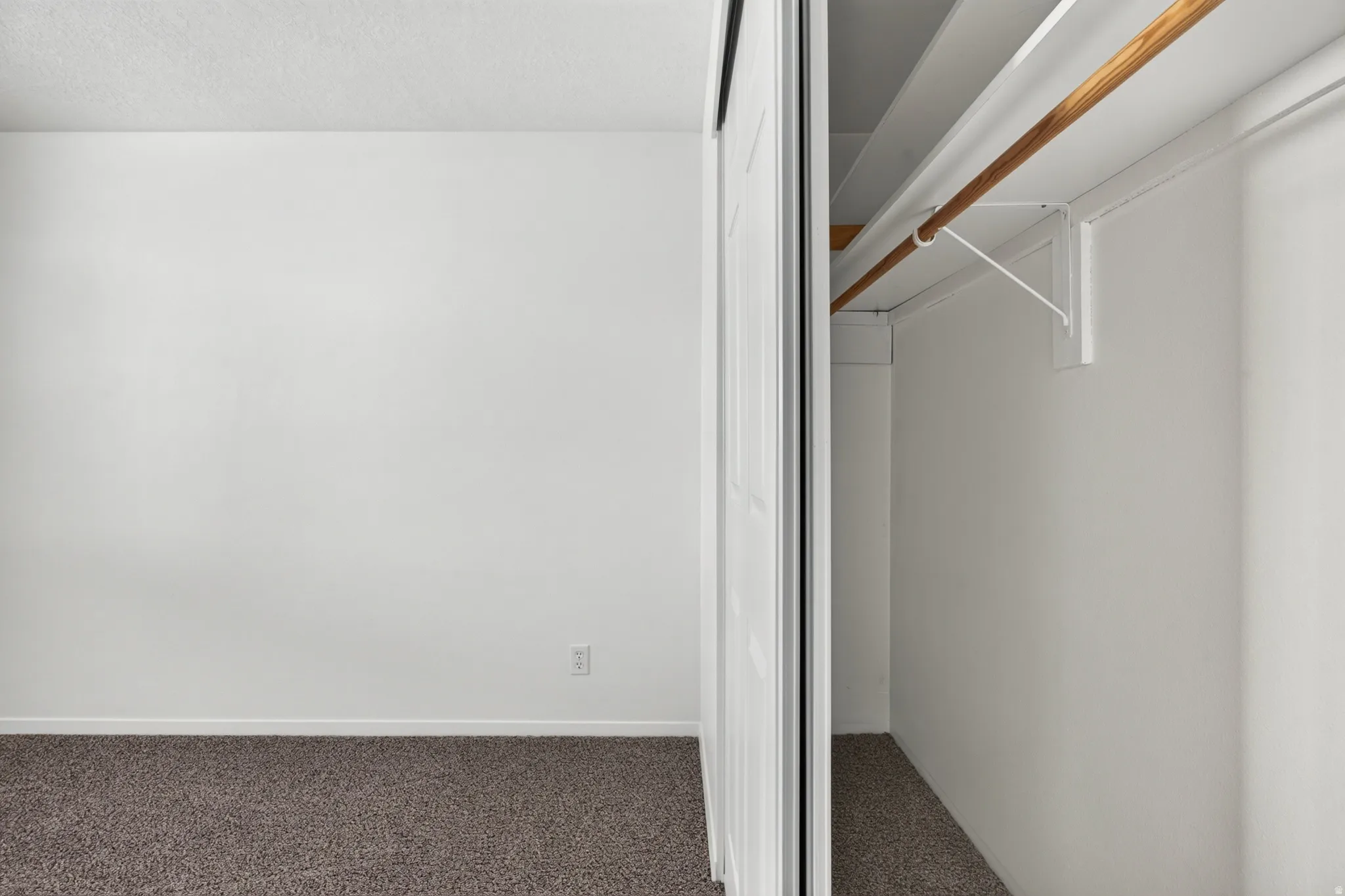 White walls and brown carpet flooring