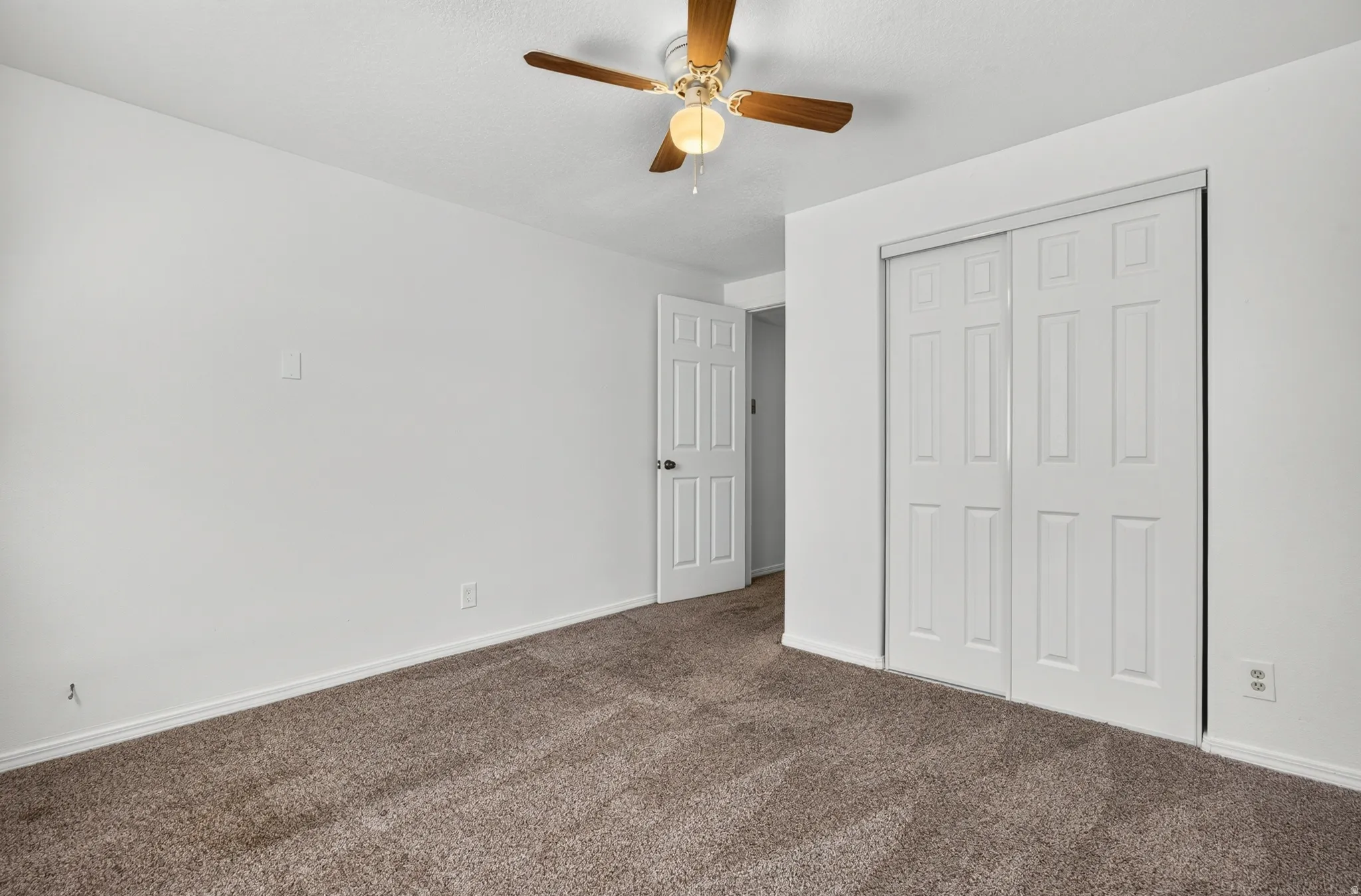 White walls with brown carpet flooring