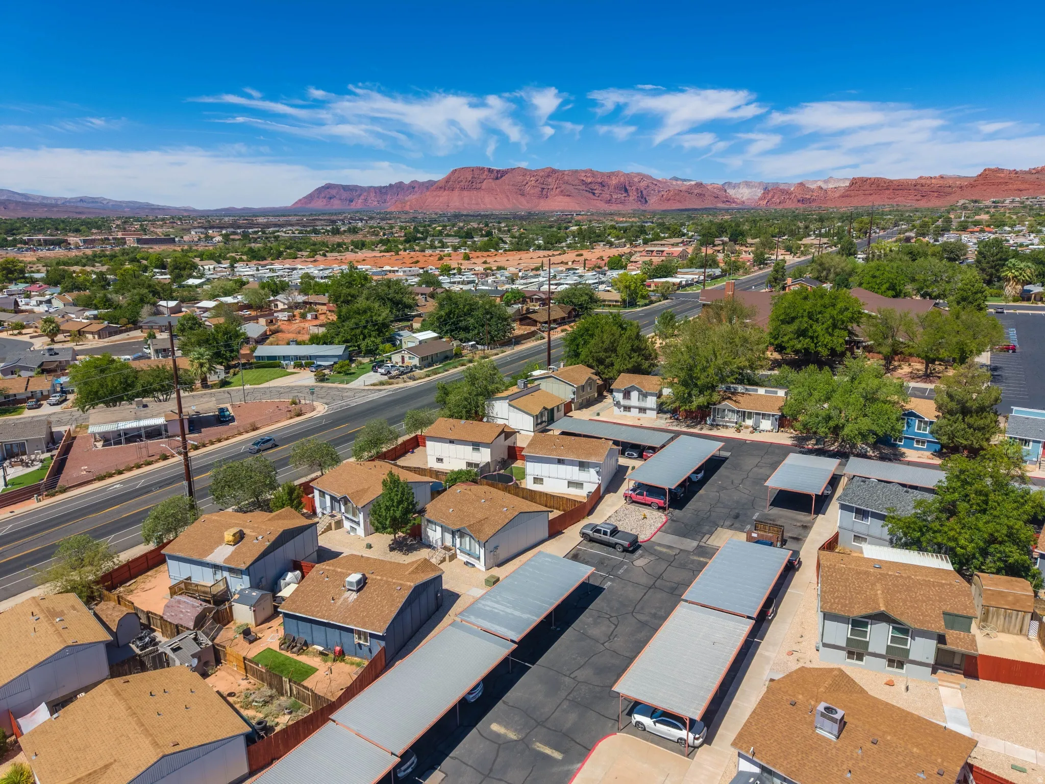 Residential properties with brown roofs and covered parking structures