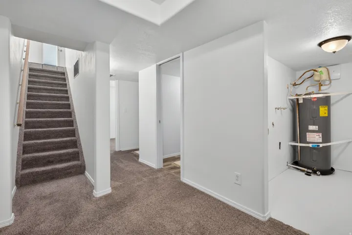 Carpeted staircase with wooden handrail
