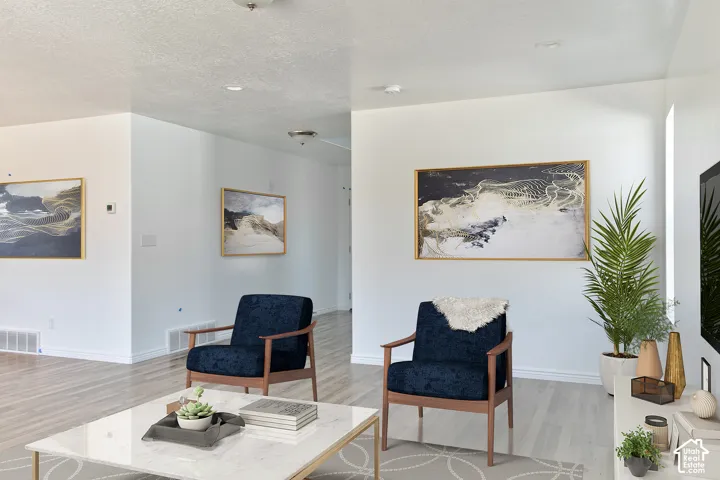 Light wood-finish flooring complements crisp white walls