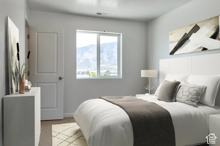 Crisp white walls, carpeted flooring, white paneled door, and a prominent window