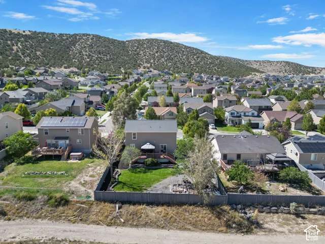 Well-maintained residential street with a mountainous backdrop