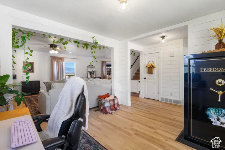 Light wood-finish flooring extending through an open archway