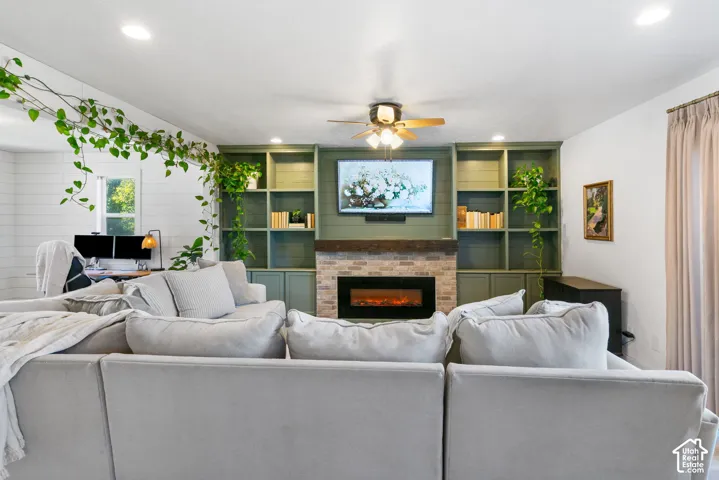 Built-in shelving flanking a central fireplace with stone-finish surround