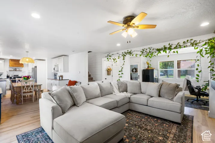 Wood-finish flooring throughout, with a ceiling fan and recessed lighting