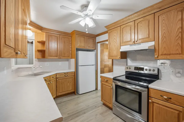 Cozy kitchen with lots of storage, stainless steel range and dishwasher and LVP flooring