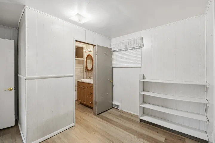 Primary bedroom sitting area bookshelves and LVP flooring