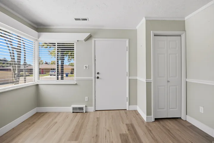 Sunny entry with updated LVP and coat closet