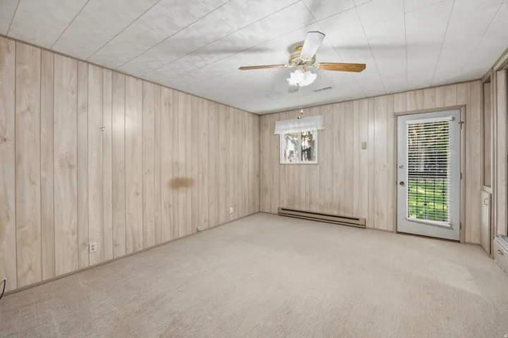 Primary bedroom with separate sitting area, ensuite bathroom, full wall of closets and direct access to the backyard