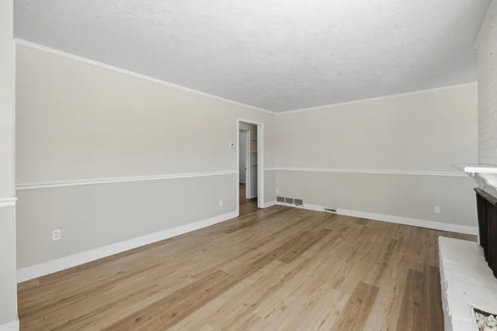 Spacious living room with welcoming fireplace