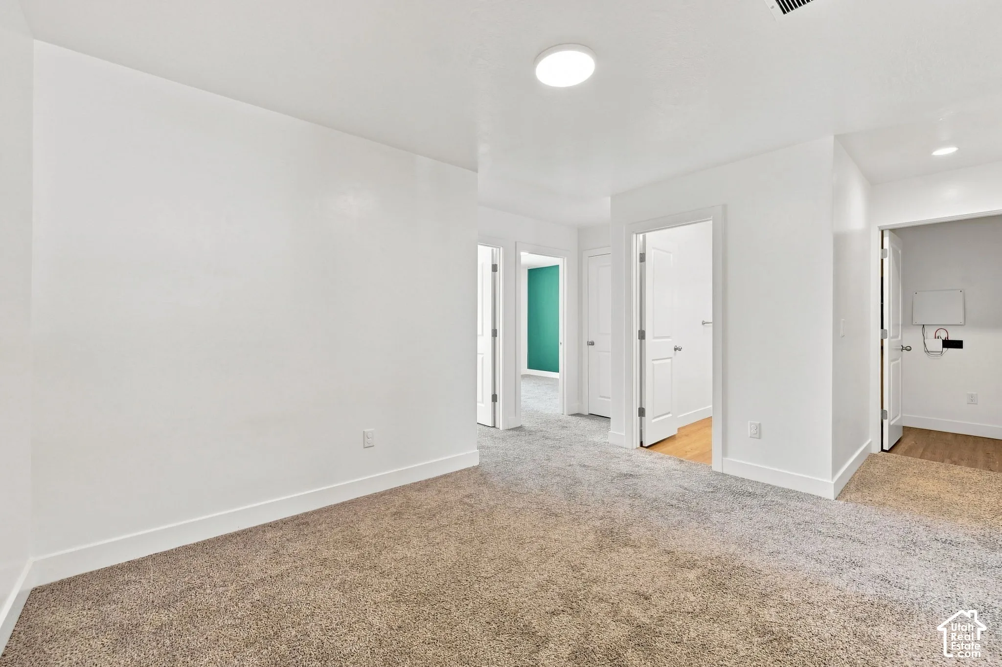 Plush carpeting, recessed lighting, white interior doors, and white baseboards