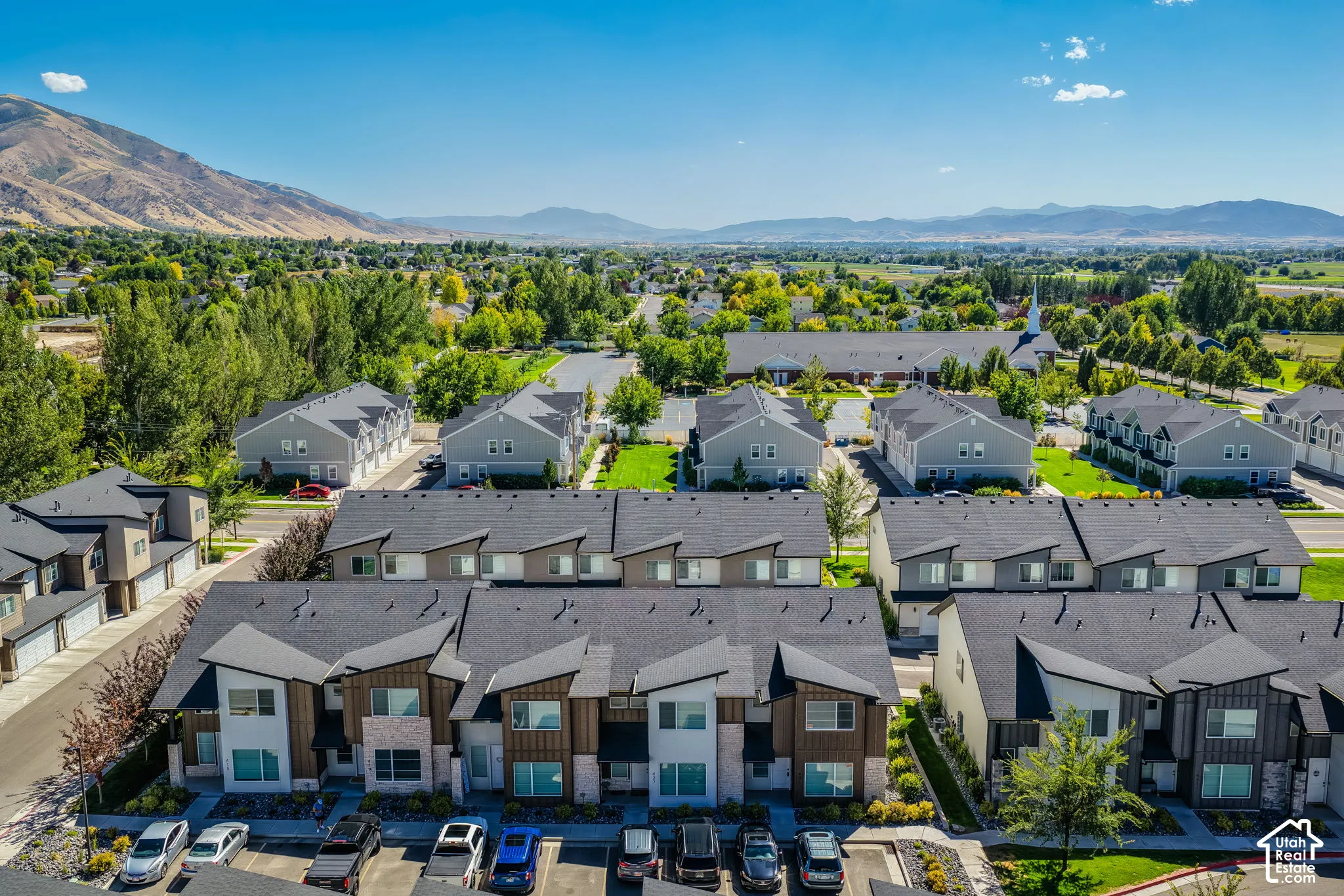 Modern townhome community featuring contemporary architectural design, multiple units with attached garages, and structured parking
