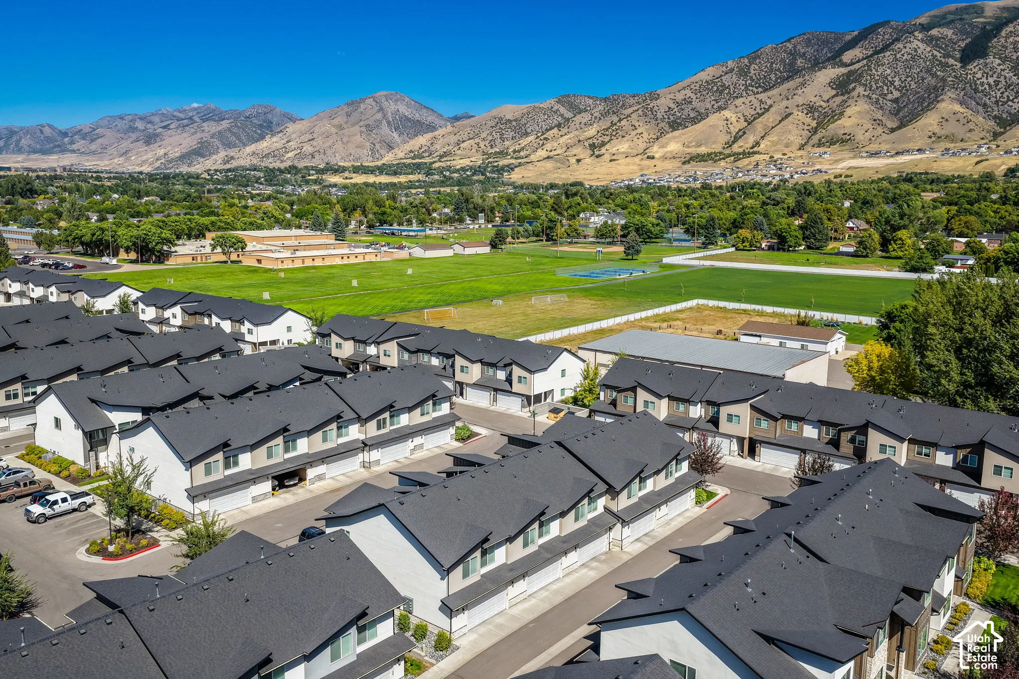 Townhome community featuring contemporary architecture, dark roofing, and attached garages