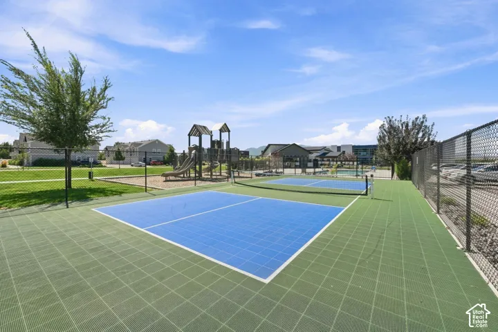 Multiple sports courts, a playground structure, and expansive green space