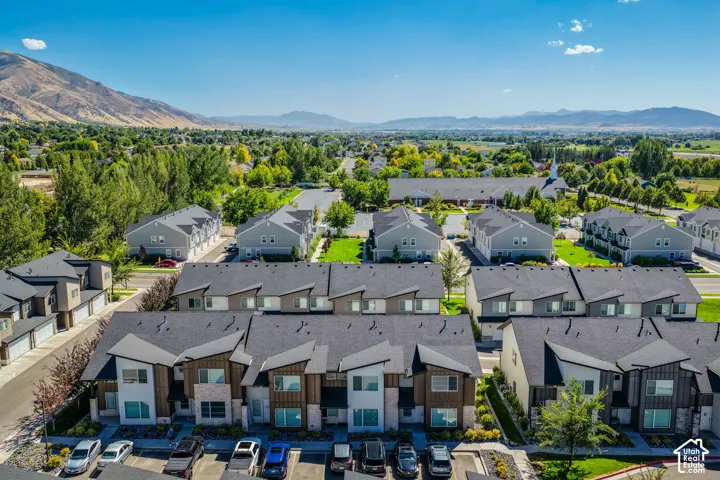 Modern townhome community featuring contemporary architectural design, multiple units with attached garages, and structured parking