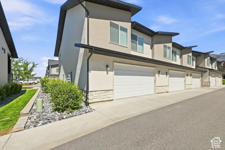 Contemporary exterior with stucco siding and stone accents