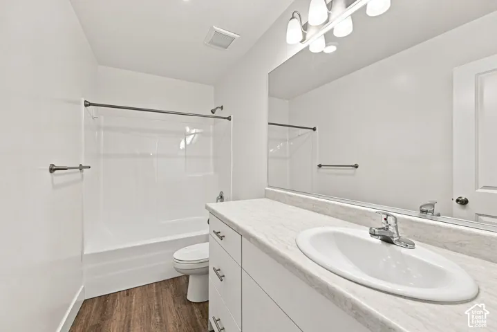 Built-in vanity with an integrated sink, polished chrome faucet, and a large wall-mounted mirror