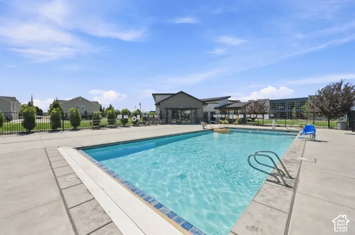 Outdoor swimming pool with integrated steps, surrounded by a concrete deck