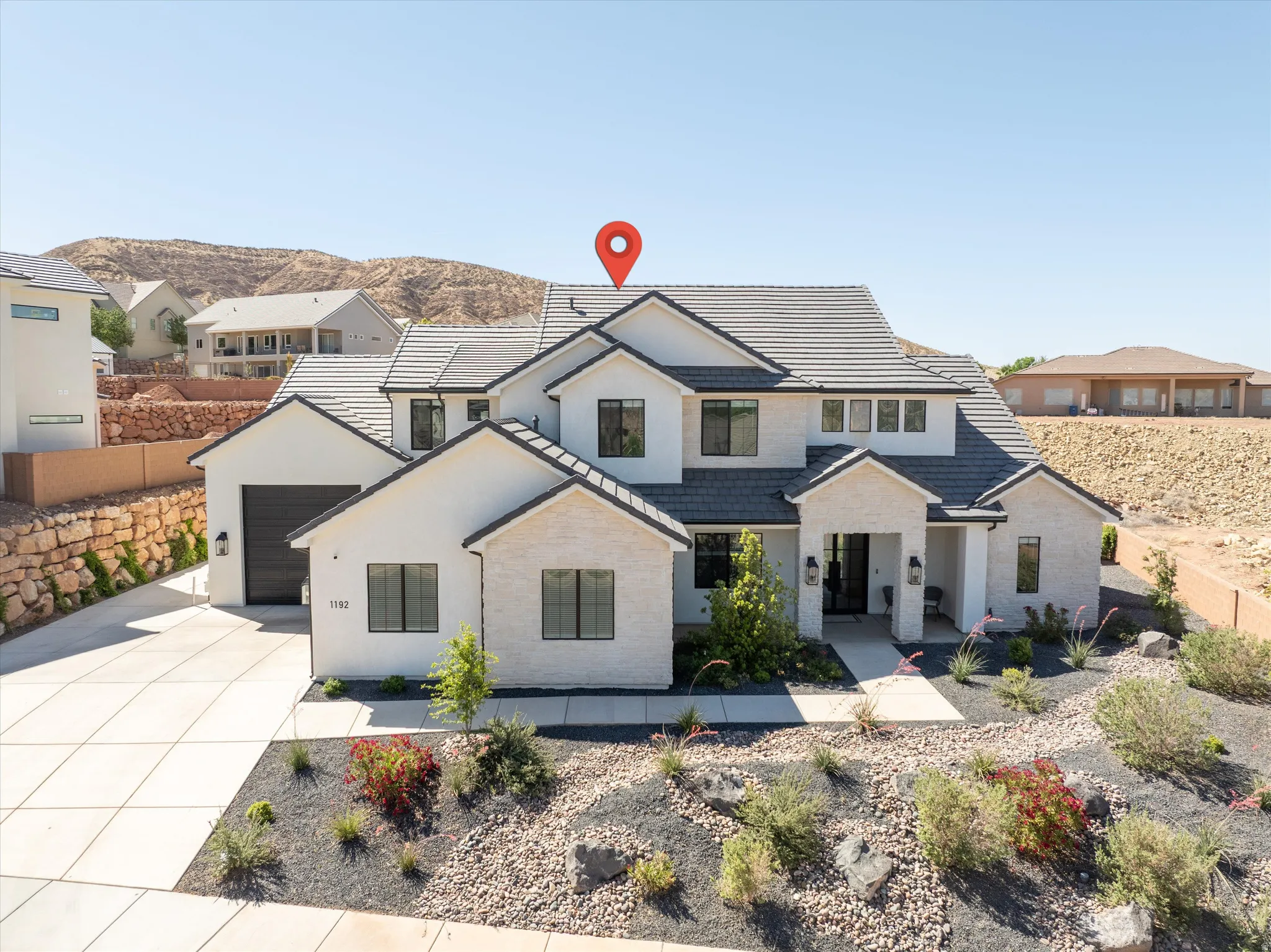Modern exterior with white stucco and light-colored stone accents