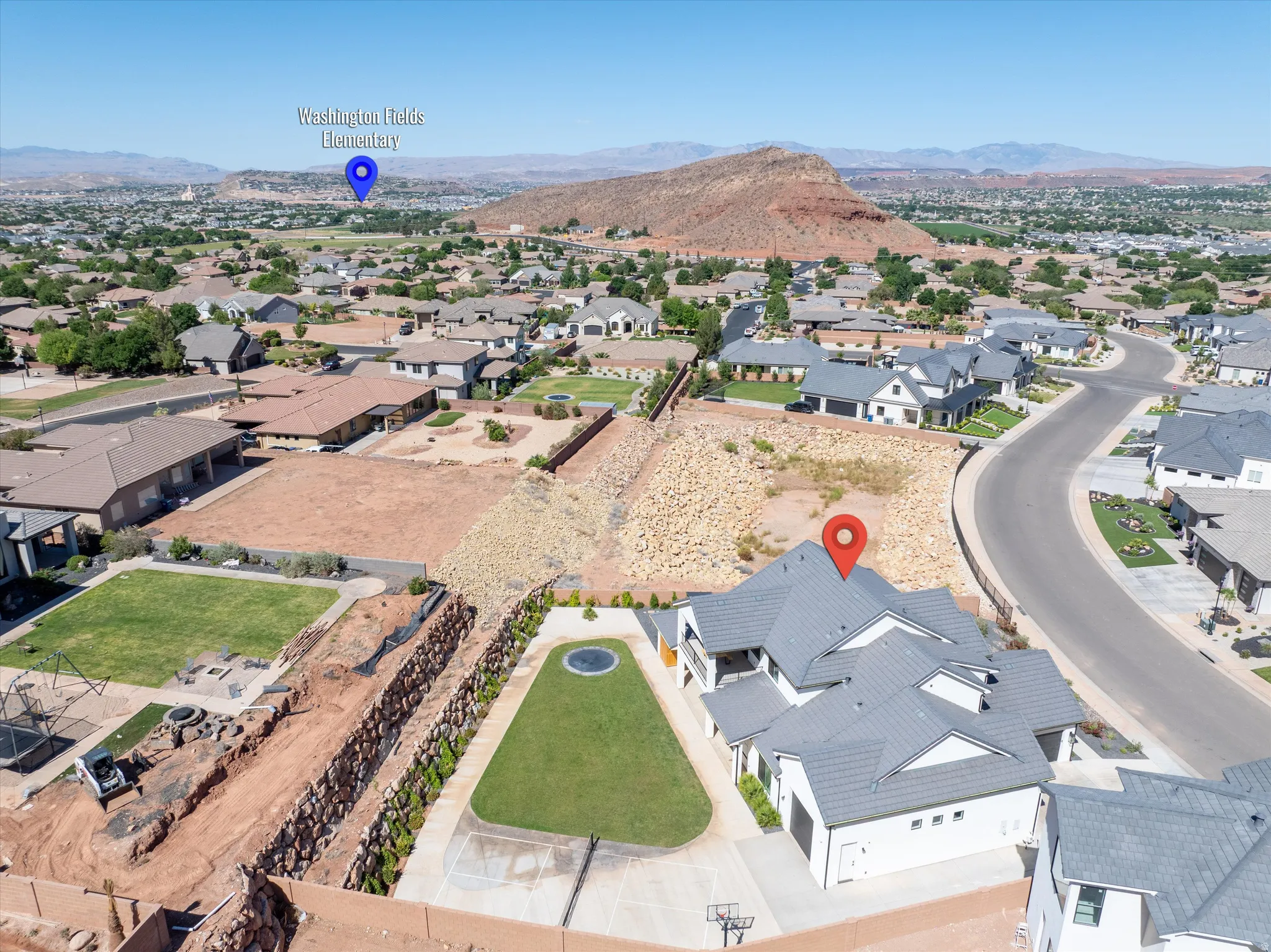 Aerial perspective showcasing a residential neighborhood with distant mountain scenery