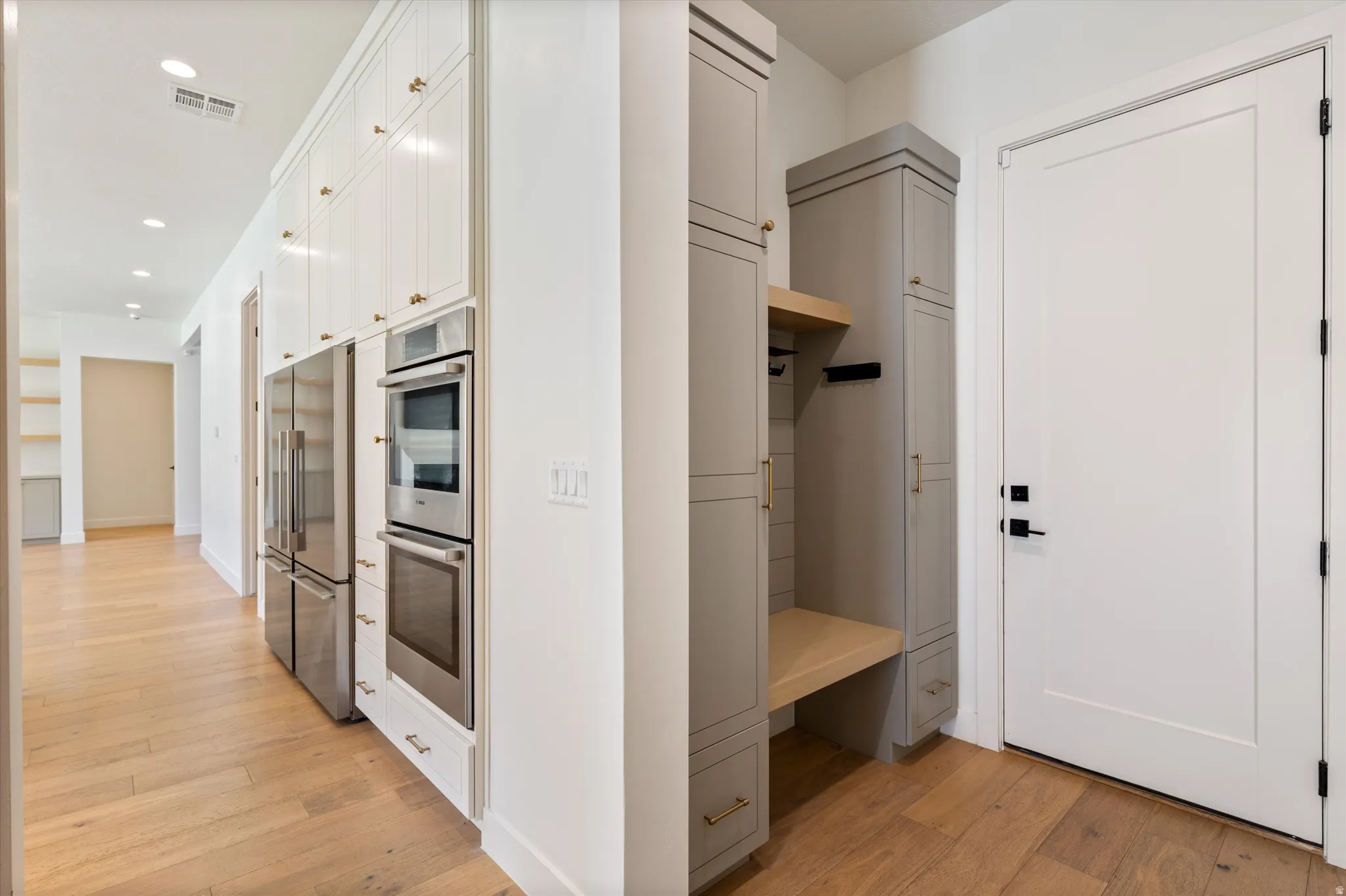 Contemporary kitchen featuring stainless steel dual wall ovens, refrigerator with French doors, and integrated appliances