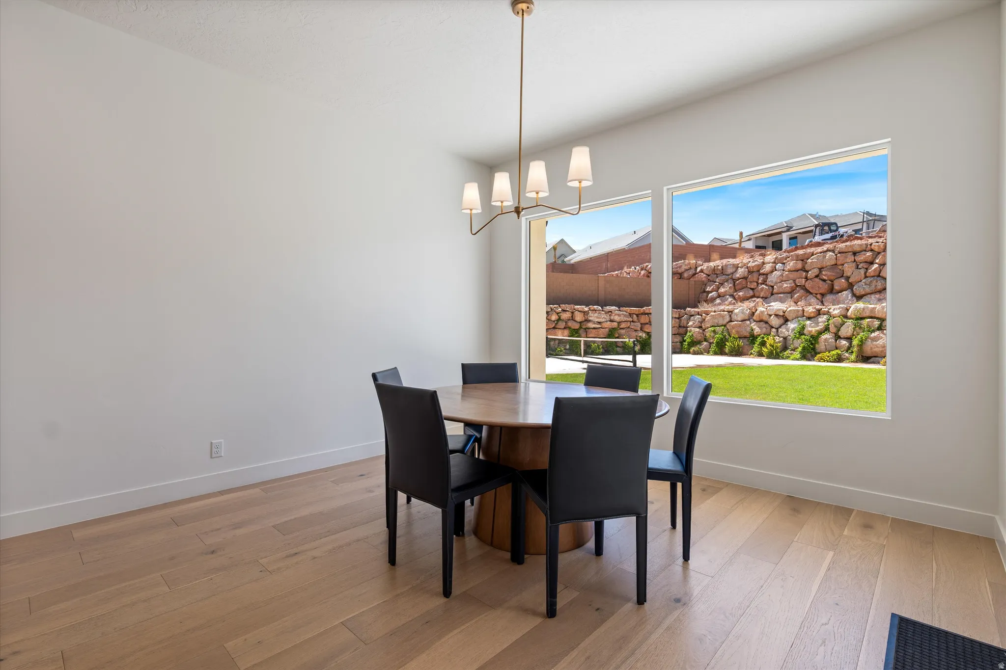 Light wood-finish flooring with white walls and trim