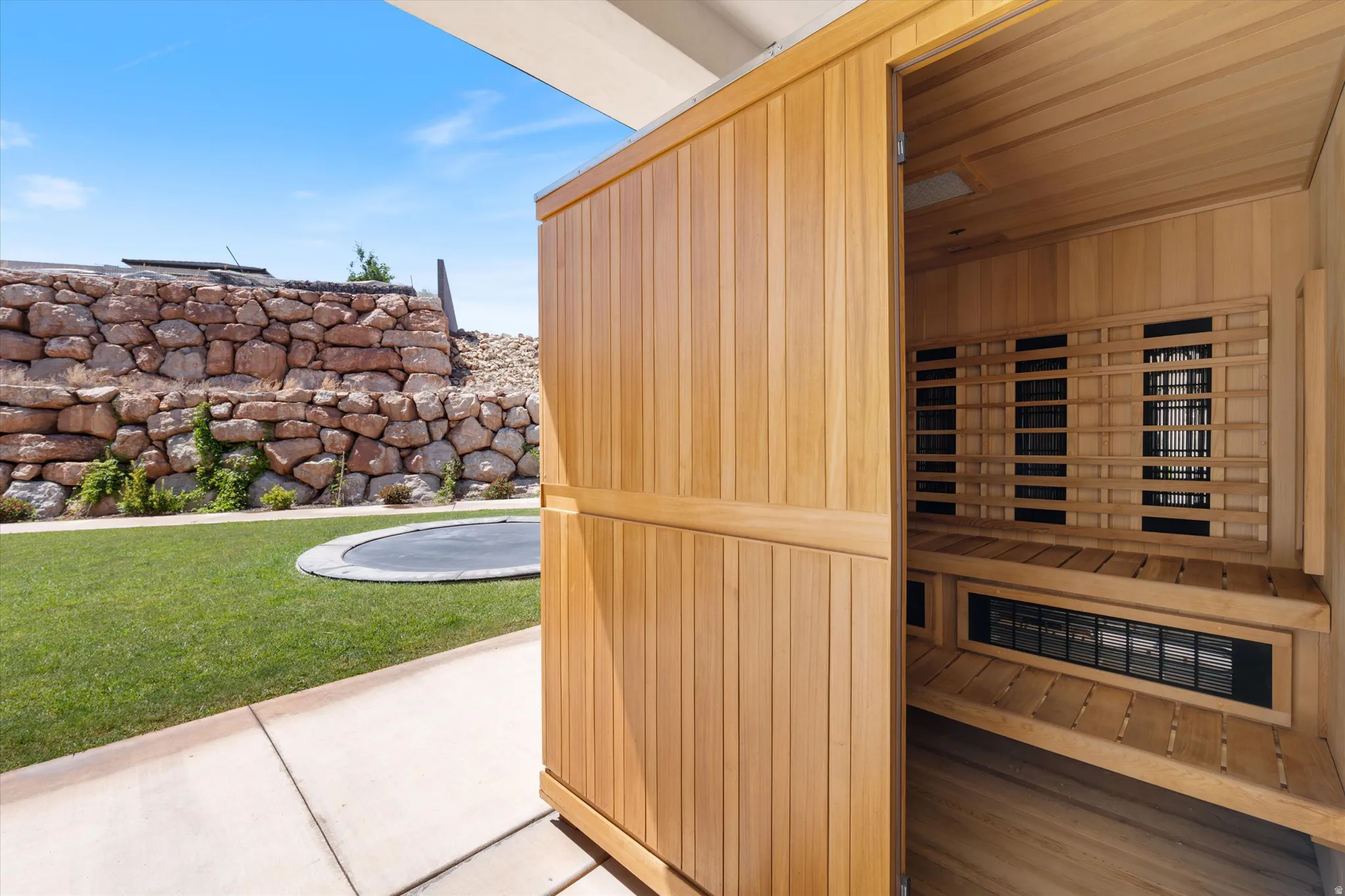 Outdoor cedar sauna with slatted interior benches