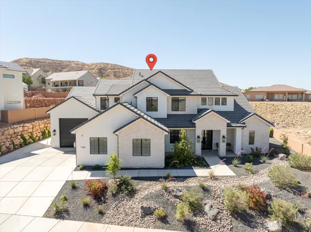 Modern exterior with white stucco and light-colored stone accents