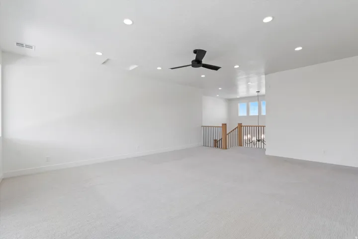 Spacious room with recessed lighting, ceiling fan, and carpeted flooring