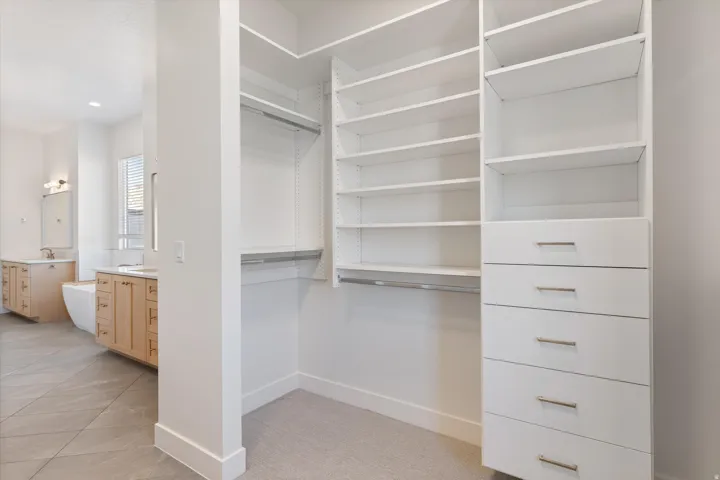 Custom closet organization system with integrated shelving and drawer storage