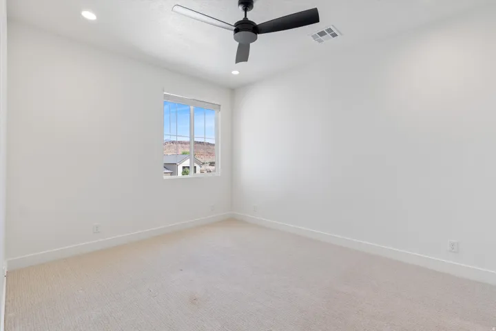 Recessed lighting, carpeted flooring, a ceiling fan, and a prominent window