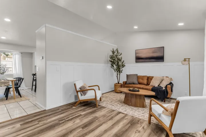 Wood-finish flooring throughout, complemented by recessed lighting and wainscoting paneling