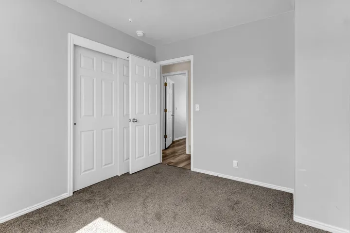 Grey carpeting throughout, white trim, and light grey walls