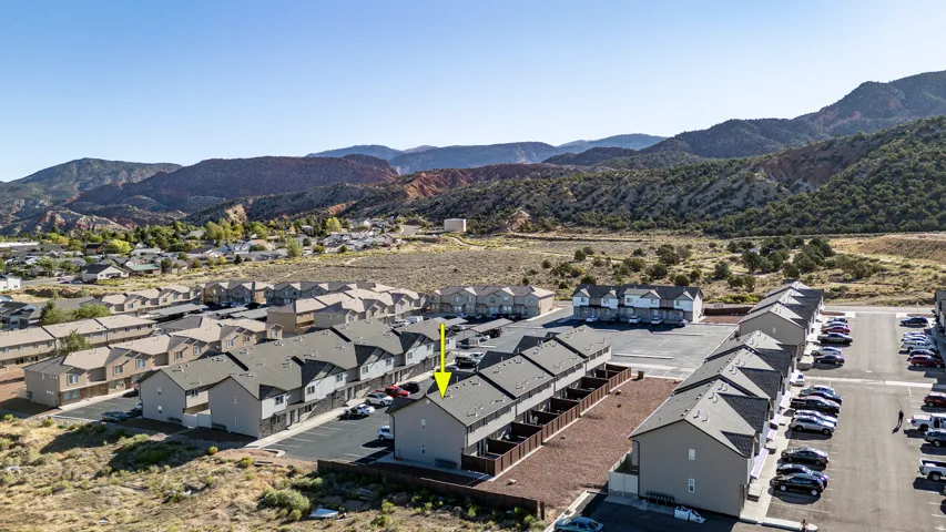 Townhome community featuring gravel landscaping and paved parking areas
