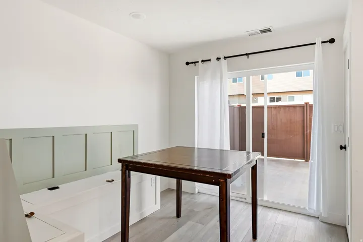 Recessed ceiling lighting, wood-finish flooring, sliding glass door, and outdoor hardscaping