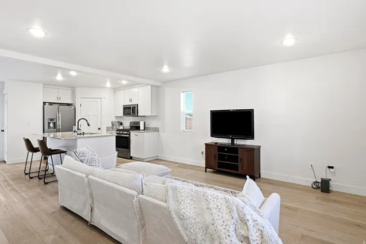 Open-concept living area with wood-finish flooring