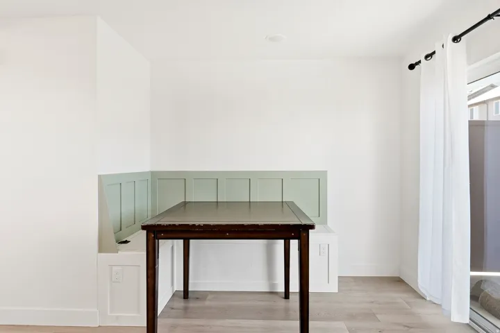 Built-in corner banquette seating with paneled backrest and integrated storage
